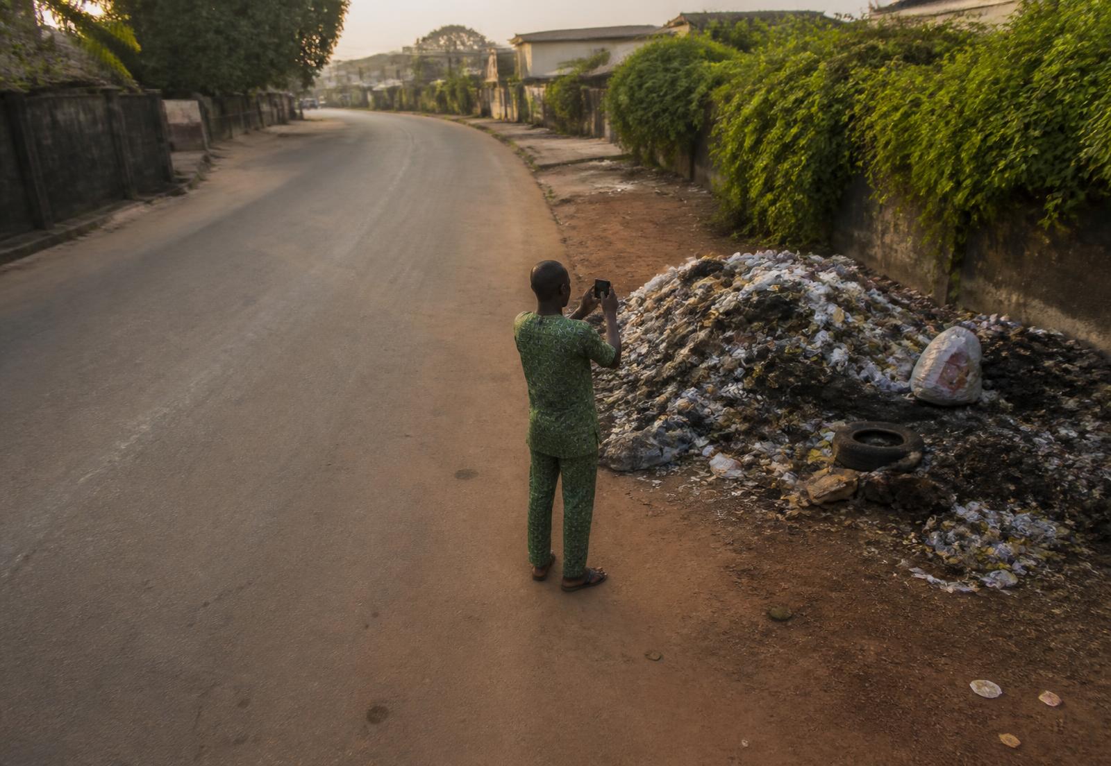 A resident documenting a waste site in their community through Waste Watch 360™